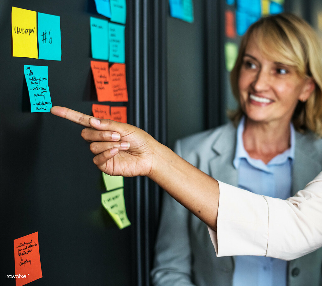 A planning wall covered in sticky notes during a program planning session
