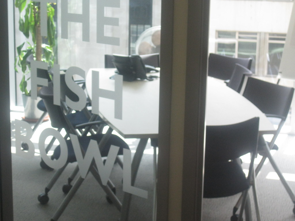 An empty glass-walled meeting room